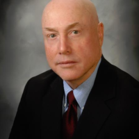 Dr. John D Comyns